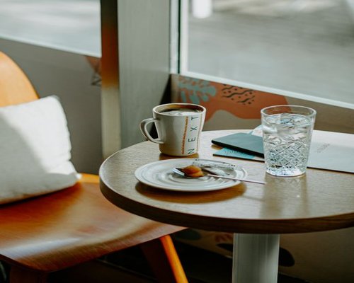 A glass of fresh water on a table next to a window